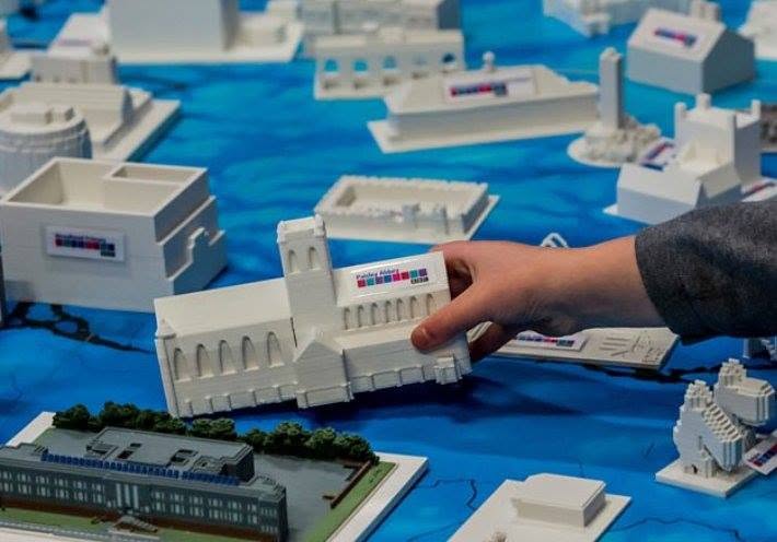 A collection of 3D-printed buildings, including Paisley Abbey, laid out on a printed map.