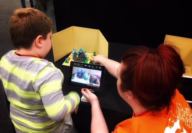 A student and facilitator using a tablet to 3D-scan a model at an Immersive Thinking workshop.